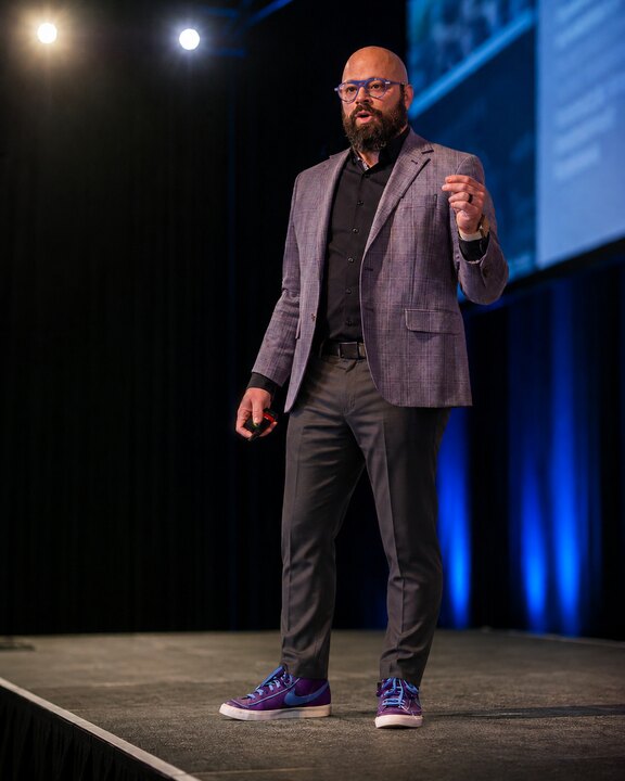 Eric Brooker speaking on stage